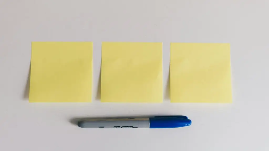 Yellow sticky notes and a marker, ready for agile sprint planning
