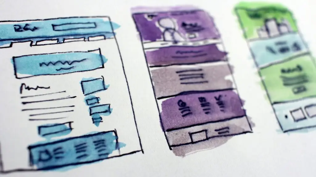 Wireframe sketches of screen layouts on paper
